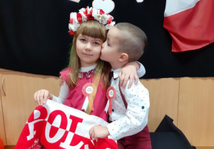 chłopiec i dziewczynka z szalikiem "POLSKA" pozują do zdjęcia