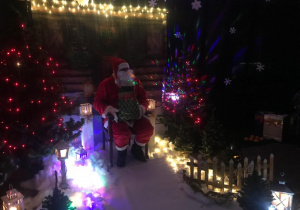 w zimowej aranżacji siedzi Mikołaj na specjalnie przygotowanym fotelu