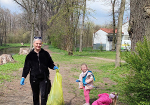 mama i dwójka dzieci zbiera śmieci
