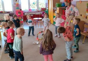 nauczycielka przebrana w jesienny stój tańczy z dziećmi