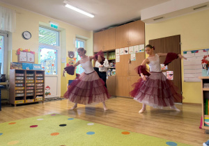 dwie artystki baletowe w scenicznych sukienkach tańczą dla przedszkolaków
